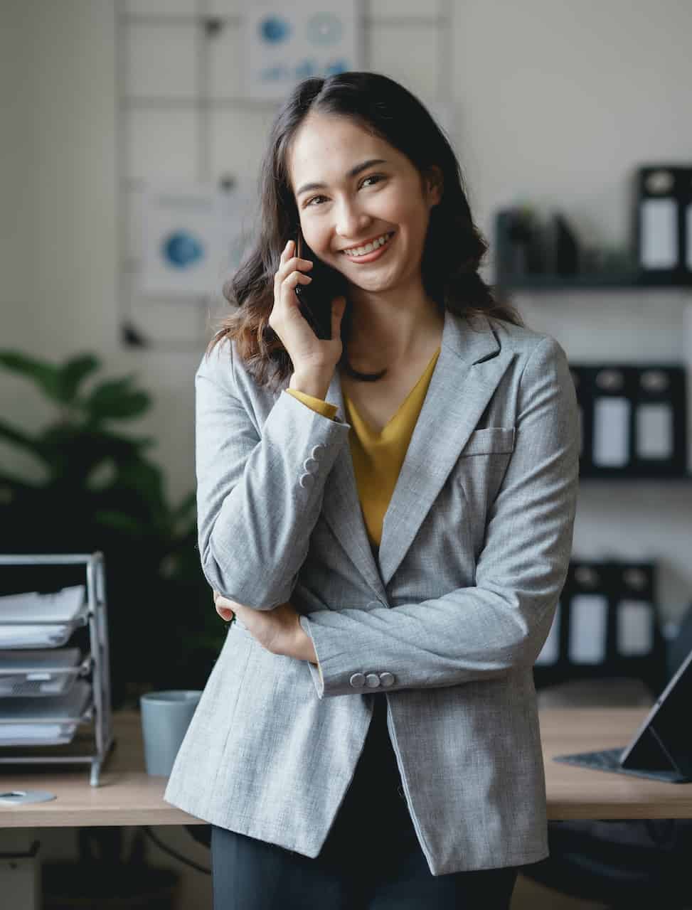 Asian businesswoman, real estate agent, talking on the phone with a customer about the details of selling a house How to buy a house step by step in the office and use the tablet. Asian businesswoman, real estate agent, talking on the phone with a customer about the details of selling a house How to buy a house step by step in the office and use the tablet.